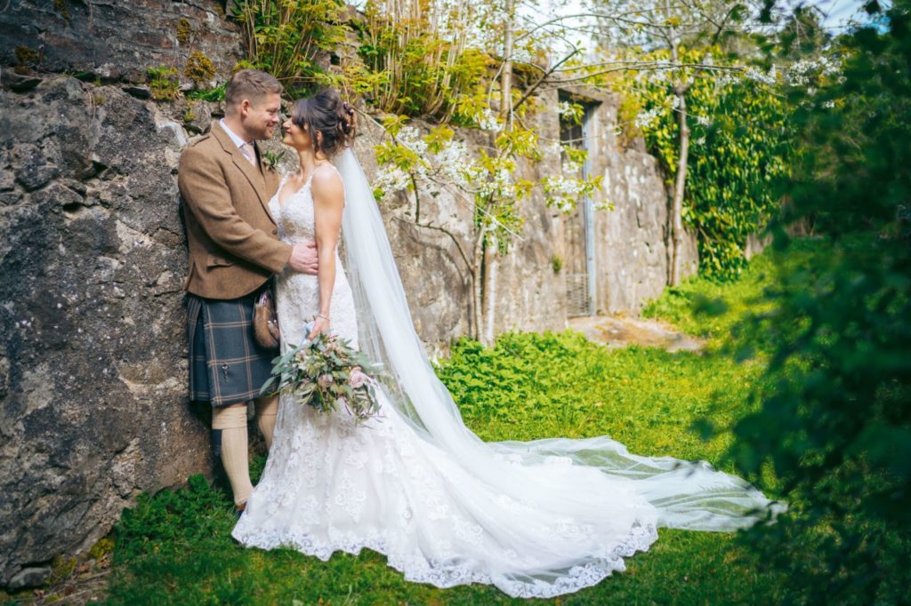 Bride and groom in walled garden at Elsick House