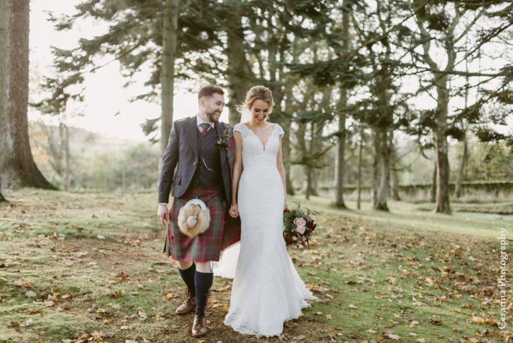 Bride and groom taking romantic stroll in woods at Elsick House Wedding
